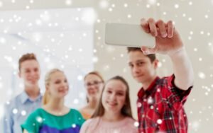 group of students taking selfie with smartphone